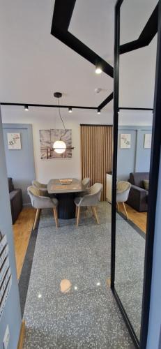 a living room with a table and a couch at Modern Mountain in Kolašin