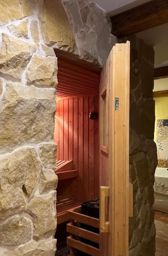 a room with a stone wall and a wooden door at Landhaus de Gaspary in Seehausen am Staffelsee