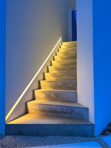 a staircase in a house with a blue light at Boutique Hotel - Casa Esteval in Rocha Amarela
