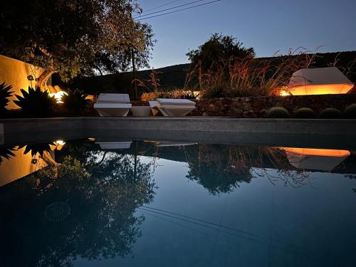 a pool of water with three bowls on top of it at Boutique Hotel - Casa Esteval in Rocha Amarela