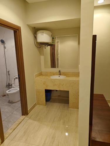 a bathroom with a sink and a toilet at حي المطار King Khalid Airport Community Apartment in Riyadh