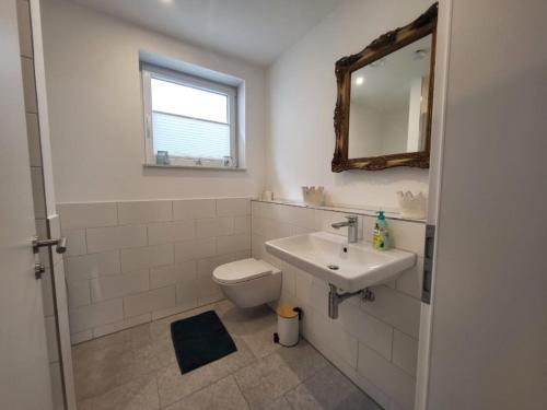 a bathroom with a toilet and a sink and a mirror at Landliebe - b48899 in Stein