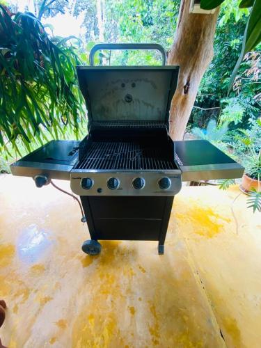 a bbq grill sitting on top of a patio at Villas Don Che, 2 villas in Jarabacoa