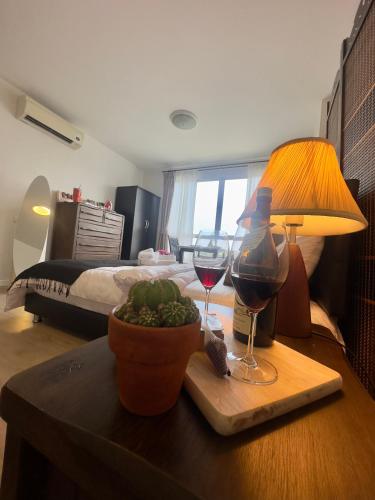 a room with a table with wine glasses and a bed at 350 METER BEACH , Center of the City in Hua Hin