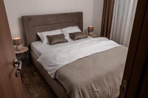 a bedroom with a large bed with two pillows at Olive Grove in Bar