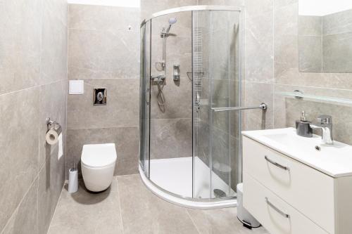 a bathroom with a shower and a toilet and a sink at Penzion Fiesta in Prostějov