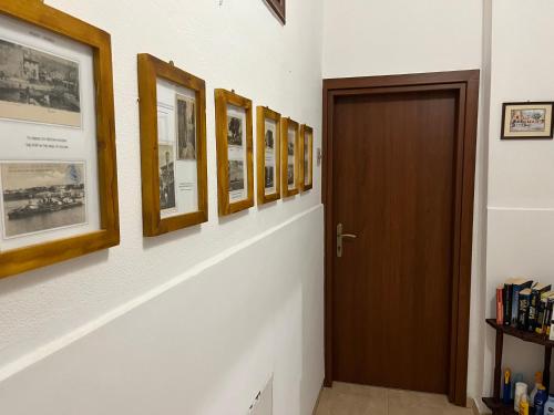 a hallway with a row of pictures on the wall at Eleni Rooms in Rhodes Town