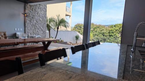 a dining room with a table and chairs and a large window at Lake's House in Socorro