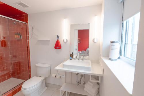 a bathroom with a toilet and a sink and a shower at The Gallatin in Nashville