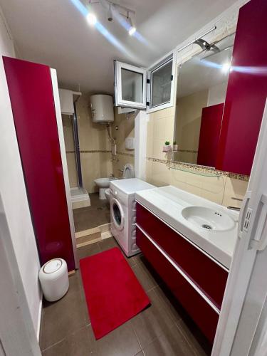 a bathroom with a sink and a washing machine at BELLO BORGO in Taranto
