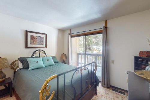 a bedroom with a bed and a large window at Shaver Haven Condominium in Shaver Lake