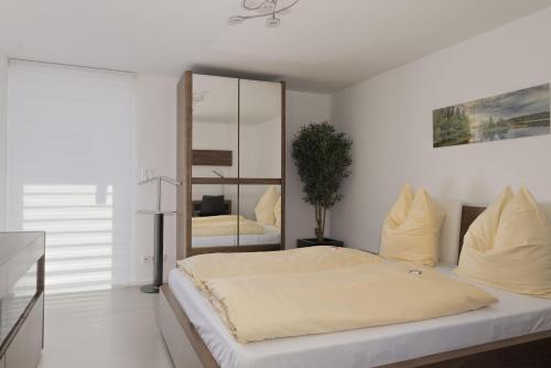 a bedroom with a bed with a large mirror at Wohnung-mit-Panoramablick in Buchenberg