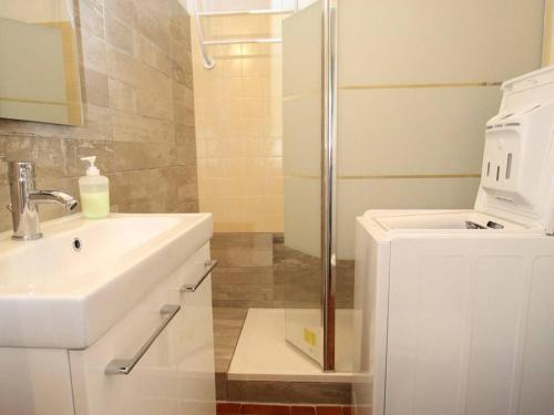 une salle de bain blanche avec un lavabo et une douche dans l'établissement Studio rénové avec wifi, balcon et climatisation à Balaruc-les-Bains - FR-1-553-53, à Balaruc-les-Bains