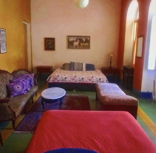 a living room with two beds and a couch at Maska Mansion Expiatorio Gdl Guest house in Guadalajara