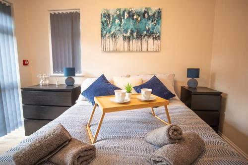 a bedroom with a bed with a table on it at Quite and comfortable Eastbourne in Eastbourne