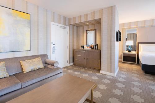 a living room with a couch and a bathroom at Caesars Palace Hotel & Casino in Las Vegas