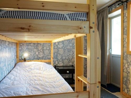 a bedroom with a bunk bed with white sheets at Holiday home Fjällbacka VII in Fjällbacka