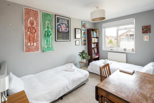 a living room with a bed and a table at Kennington 3BR Haven: Dog-Friendly/Central London in London