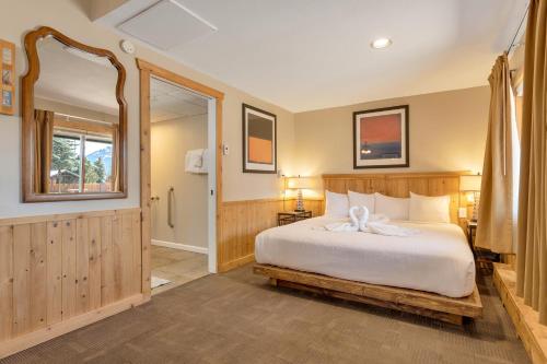 a bedroom with a bed with a white bow on it at Murphy's Resort in Estes Park
