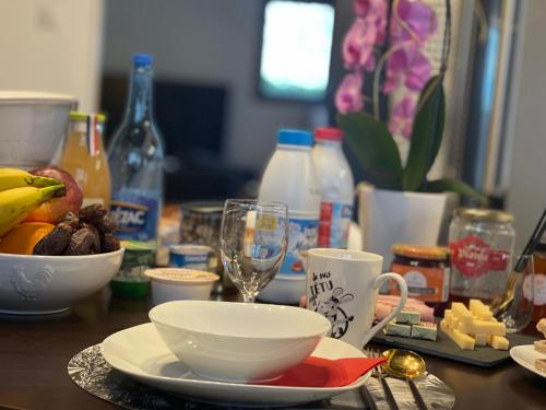 a table with a plate of food and a glass of wine at Casa Lovo in Saint-Laurent-de-Mure