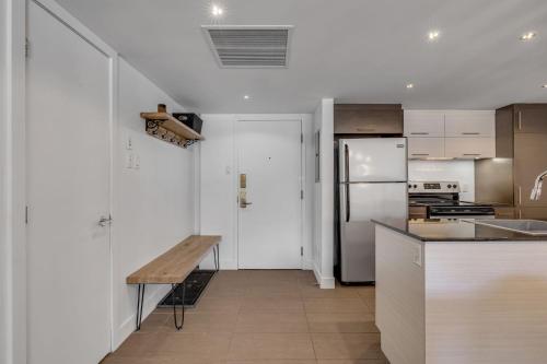a kitchen with a wooden table and a refrigerator at Initial / La Crête / MSA+pool in Beaupré