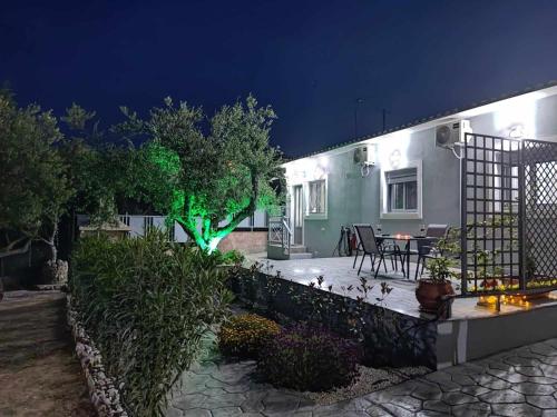 a house with a garden at night at Il Mio Riposo in Vasilikos