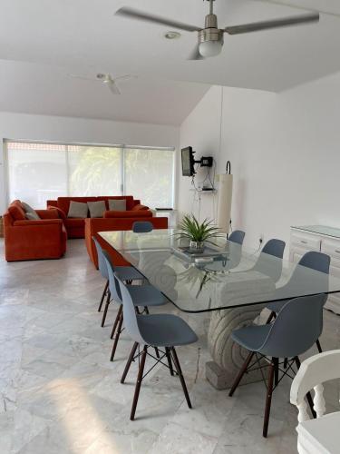 a living room with a glass table and chairs at CASA BLANCA in Cancún