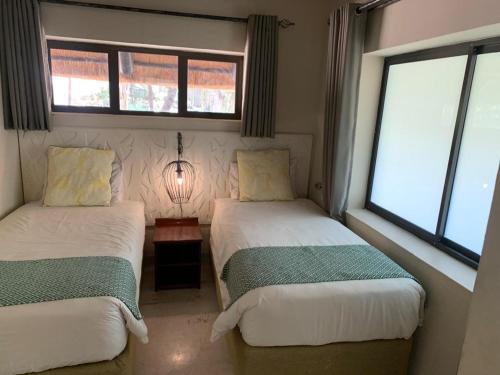 Ένα ή περισσότερα κρεβάτια σε δωμάτιο στο Masumu River Lodge