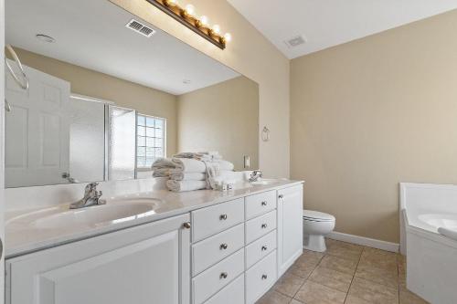 a white bathroom with a sink and a toilet at Points of View in Gulf Shores