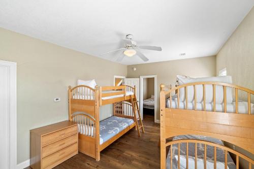 a room with two bunk beds and a ceiling fan at Points of View in Gulf Shores