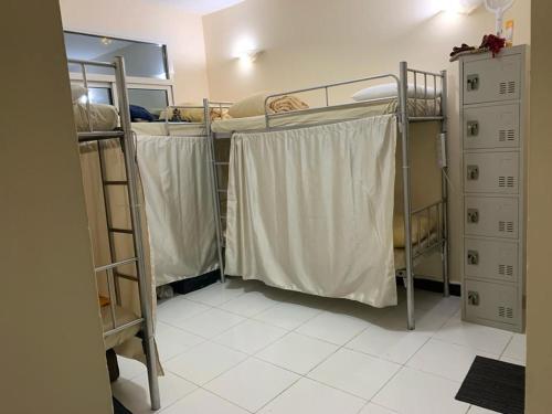 a room with three bunk beds in a room at Dubai Homes near ADCB METRO STATION in Dubai