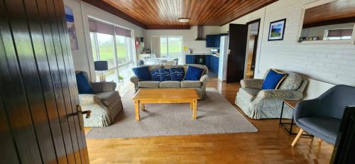 a living room with couches and a coffee table at Dolphin Watch Wild Atlantic Way in Fanore