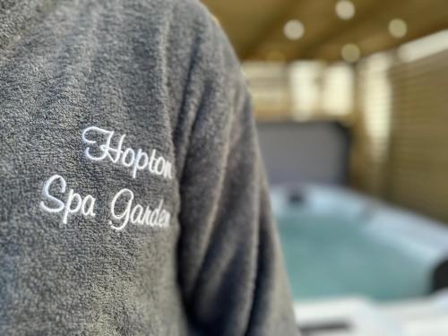 a person wearing a gray shirt with the words soraho sonaho at Spa Garden Cottage - Upper Hopton in Mirfield