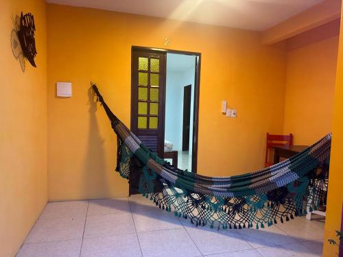 a room with a hammock hanging on the wall at Pousada Flor de Porto in Porto De Galinhas