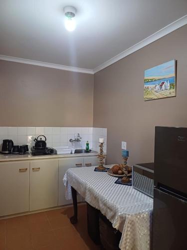 a kitchen with a table with a plate of food on it at Leipoldt street 3 in Clanwilliam