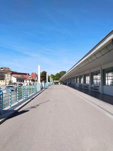 an empty road next to a building with a fence at Leier apartments in Piešťany
