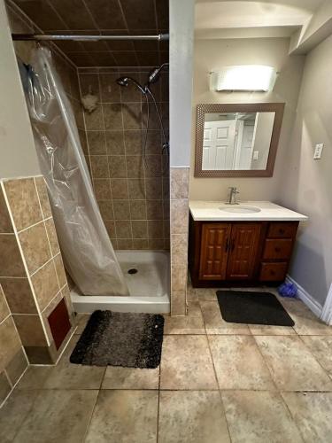 a bathroom with a shower and a sink and a tub at Pocket Friendly Room-Plaza, bus stop walking distance!3 in Kitchener