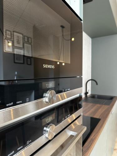 a kitchen with a stove top oven in a kitchen at Villa Frans Luxe appartement 4 slpk in Ostend