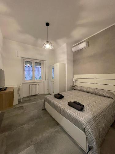 a bedroom with a large bed and a window at Maison Cristina in Lido di Ostia