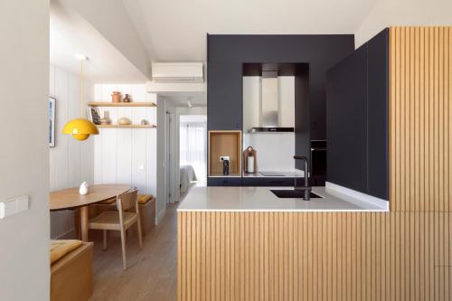 a kitchen with a table and a dining room at C211 Barcelona Apartments in Barcelona