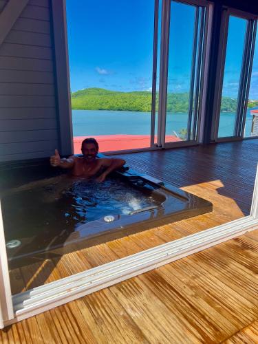a man in a hot tub in a house at coup de coeur in Le François