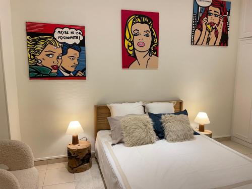 - une chambre avec 3 photos sur le mur et un lit dans l'établissement Magnifique 2pc luxe place du pin le port, à Nice