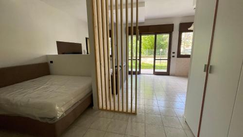 a bedroom with a bed and a sliding glass door at Residenza Europa in Budrio
