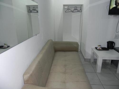 a living room with a couch and a table at De Bliss Lodge in Johannesburg