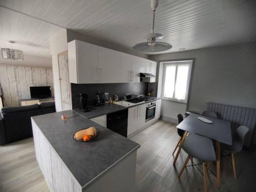 - une cuisine avec un îlot au milieu d'une pièce dans l'établissement Maison périgourdine au calme, à Grèzes