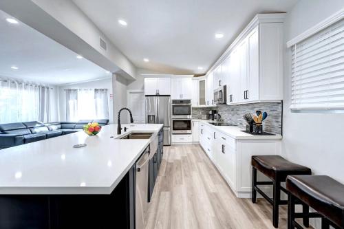 a kitchen with white cabinets and a white counter top at Walk to Beach Luxury 4BR & 4BA Villa Hollywood Lakes in Hollywood