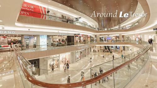 a large shopping mall with people walking in it at Le Tresor Benson Apartment at Supermal Pakuwon in Surabaya