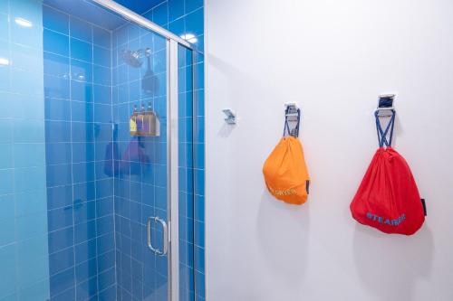 two bags hanging on the wall of a shower at The Gallatin in Nashville