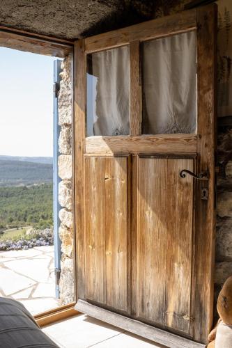 a wooden door with a window in a room at La Bergerie du Haut Var in Bargème