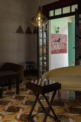 a living room with a checkered floor and a table at Villa Octavia in Mérida